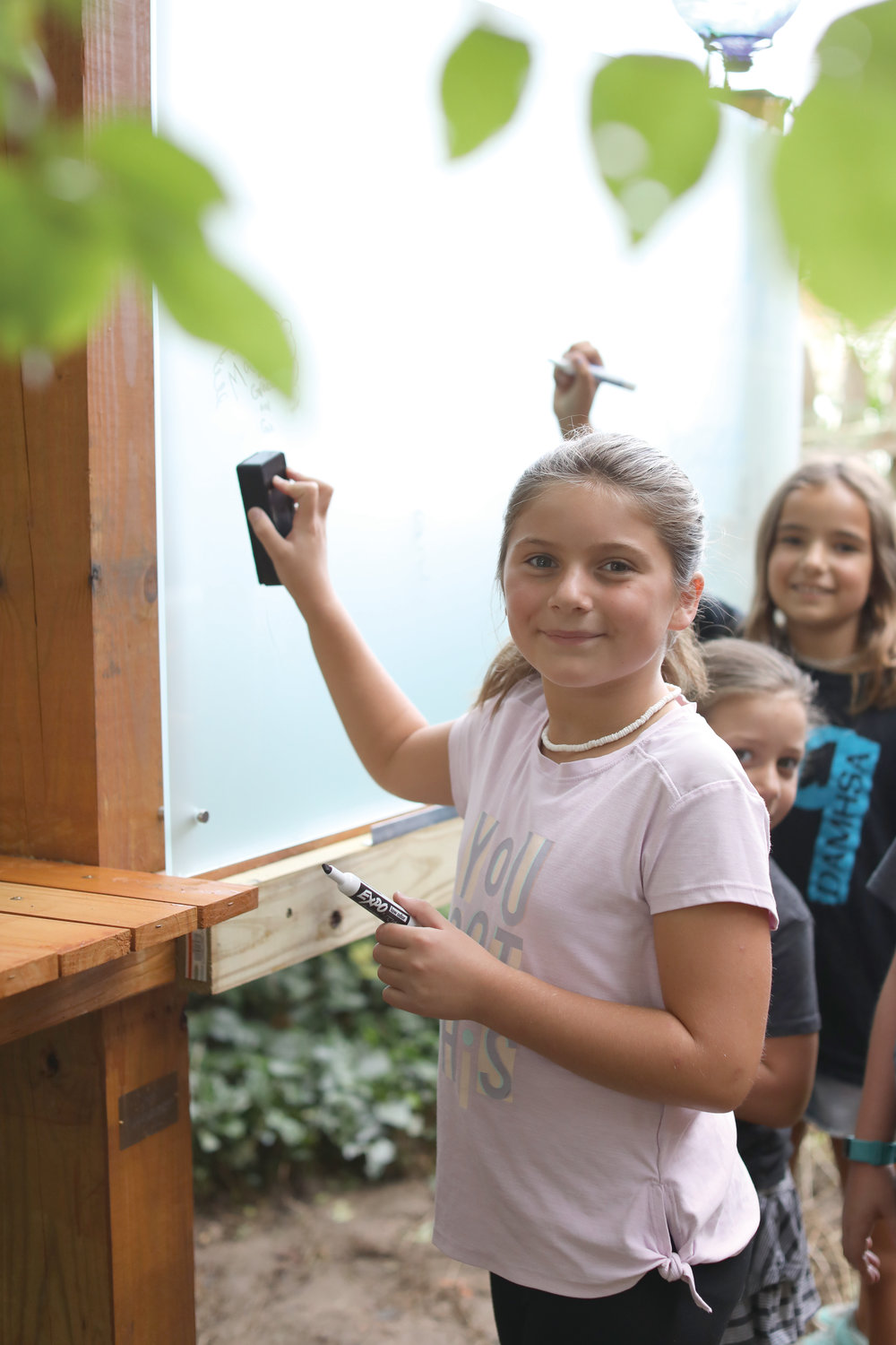 Shortly before the first day of school, students, parents and teachers help put the finishing touches on the Sister Mary Angelus Outdoor Classroom.